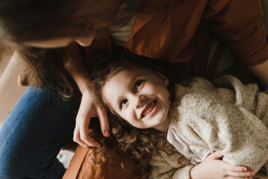 A mother and daughter has a wonderful moment as daughter is resting her head in mothers lap