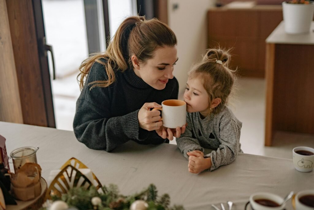 A mother drinking hot chocolate with her daughter