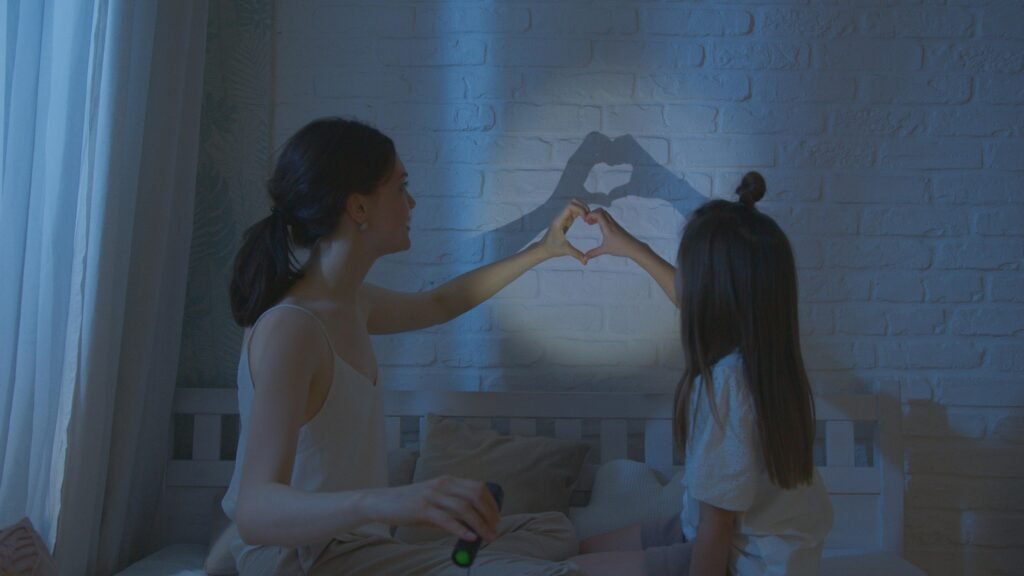 Mother playing with daughter A mother playing with making shadow figures with her daughter