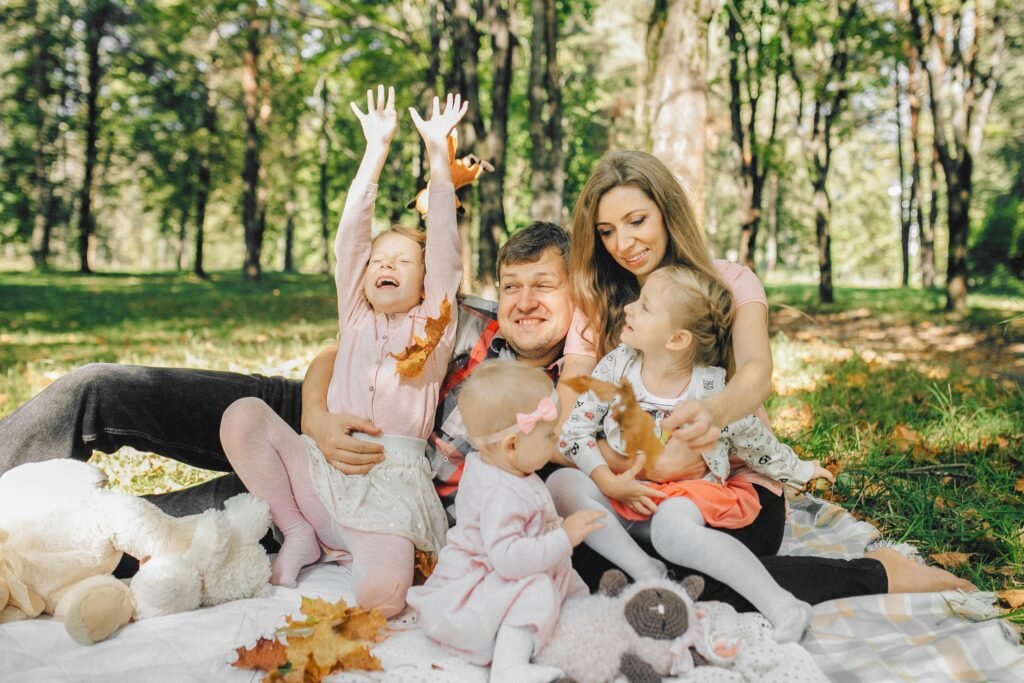 Family enjoying picnic A family is enjoying a lovely picnic in the forest. They are happy and laughing, enjoying their time