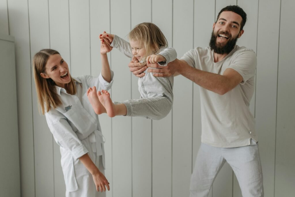 Mother, father and daughter playing together