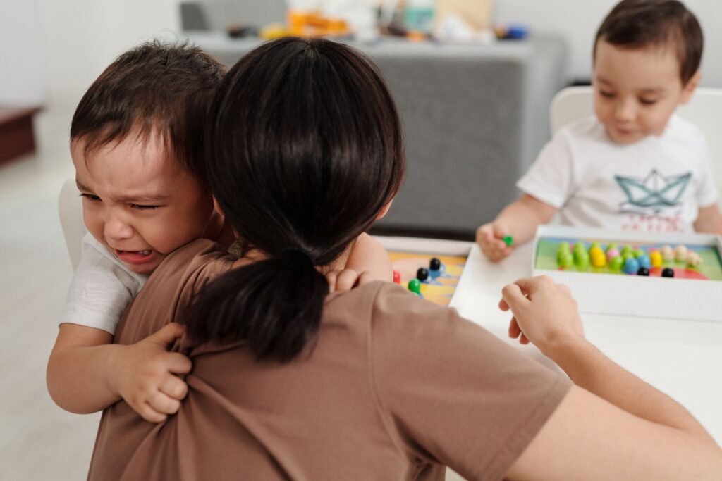 Adult comforting a young child during an overwhelming moment